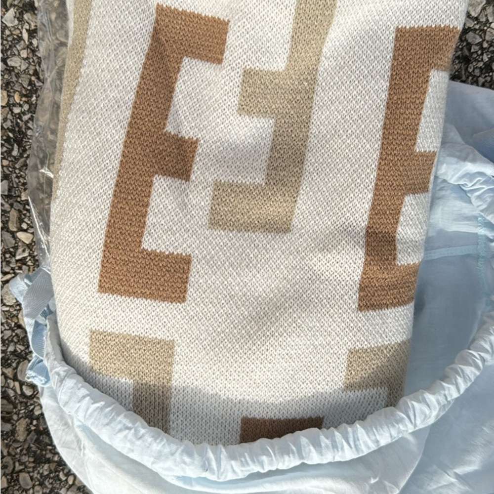 Monogram “E” blanket by bubble bar